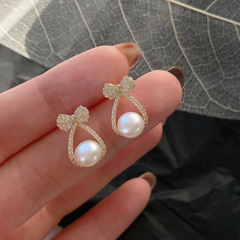 

2022 Korean Fashion New Style Personalized Diamond Inlaid Bow Earrings for Women's Creative Cross Pearl Earrings Gold Earrings
