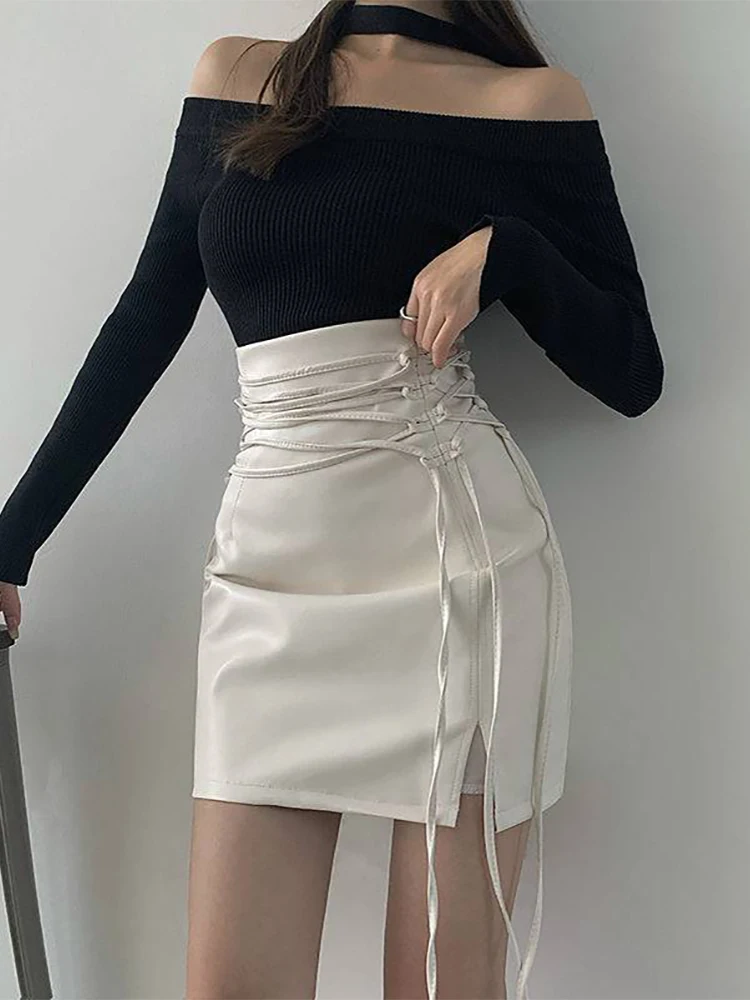 

2023 Japanese Summer Cut Out White Pencil Skirts Streetwear Bandage High Waist Pu Leather Sexy Black Slit Mini Skirt Party Women