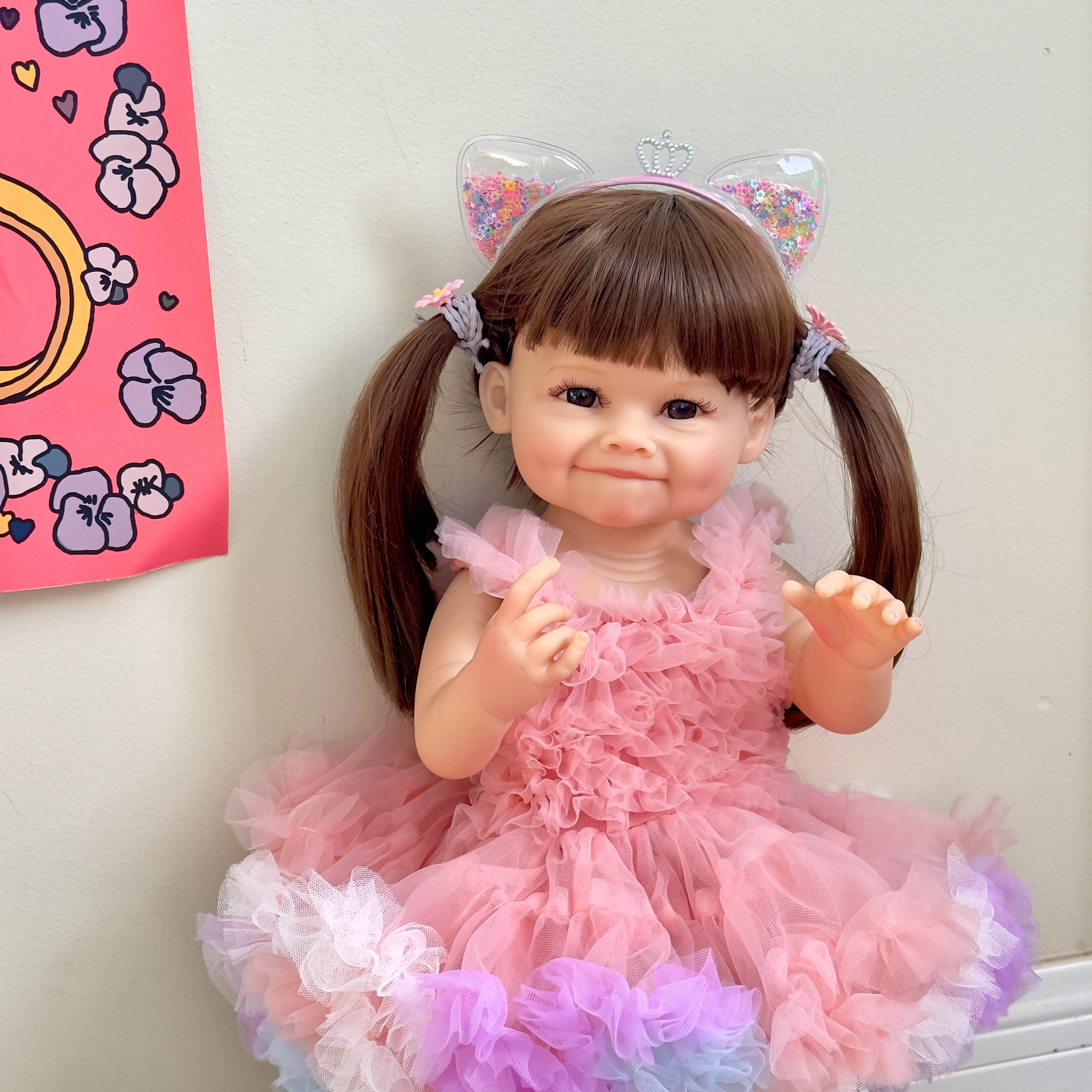 55cm full glue immersible simulation doll standing against a wall, new smiling dimpled baby