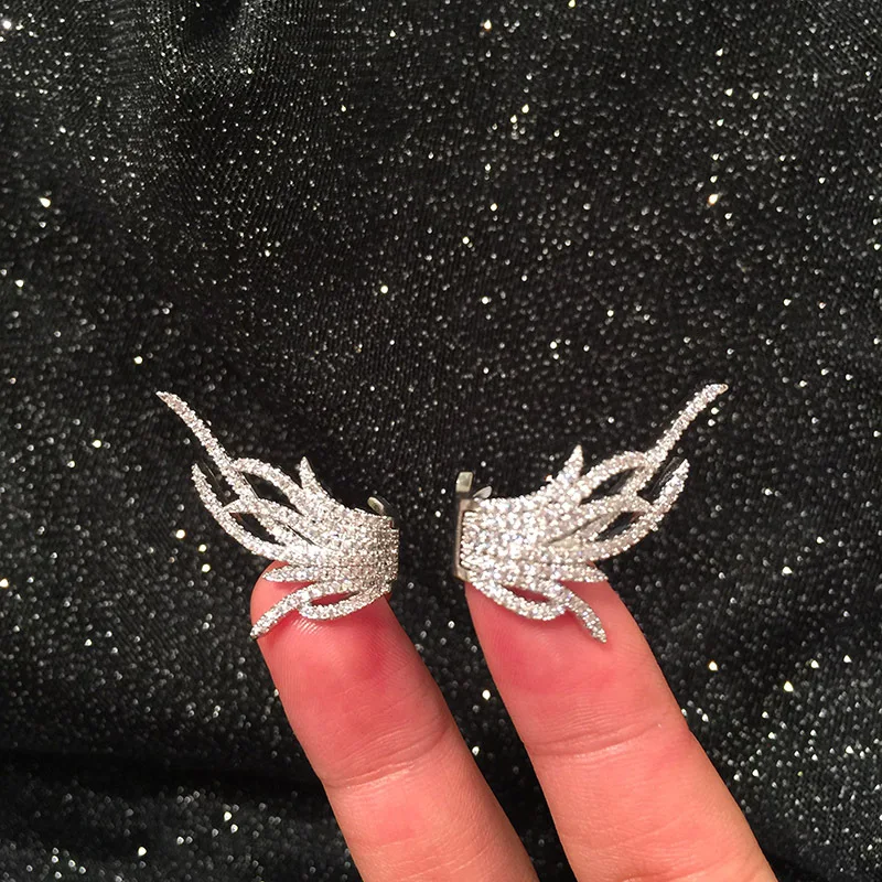 

Korean fashion super fairy feather earrings creative curve design wing ear buckle temperament net red hipster earrings micro-set