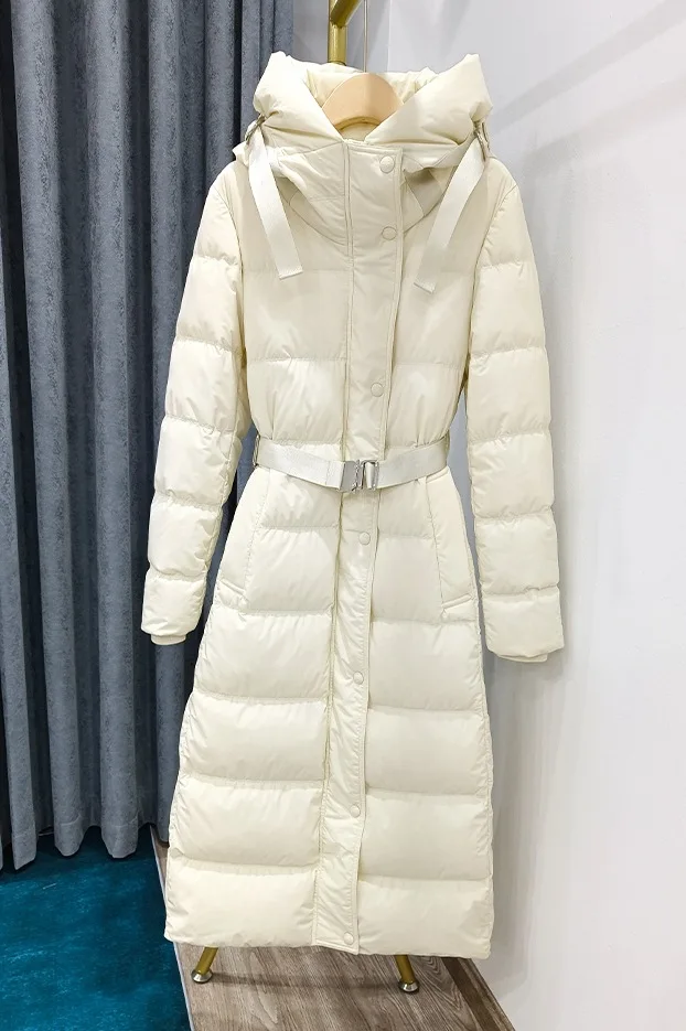 Winter 2022 New European long down jacket women's knee-length lace-up slim slim white eiderdown jacket with thick hat