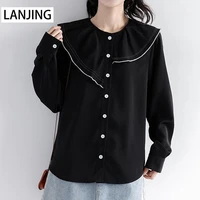2022 autumn new irregular niche design sense black long sleeved shirt womens loose shirt spring and autumn top trend