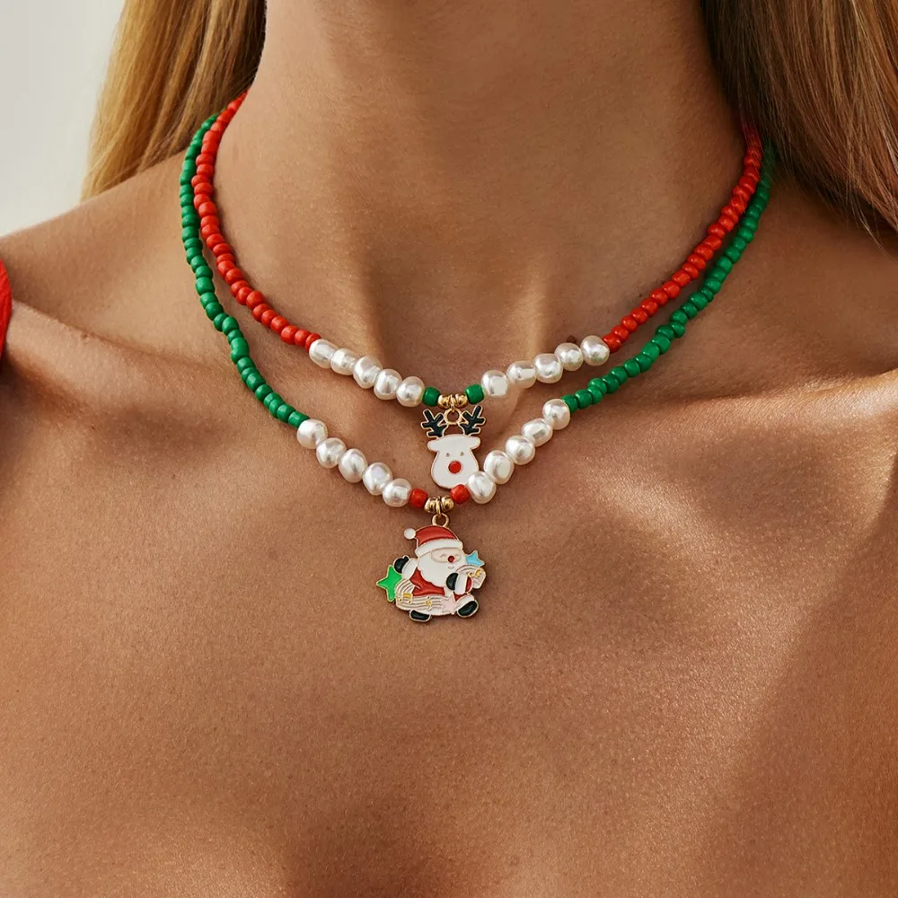 Фото 2pcs Set Trendy Cartoon Santa Claus Elk Christmas Tree Pendant Imitation Pearl Beaded Fold Wear Necklace Women Jewelry Set Gift