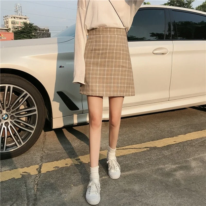 

Женская осенне-зимняя клетчатая юбка выглядит тонкой и скрывает ягодицы, облегающая юбка с сумочкой, маленькая популярная юбка для девушек