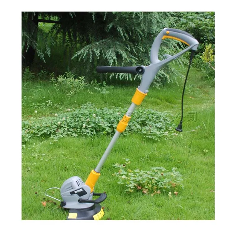 

Electric lawn mower in the yard Electric lawn mower Handheld gardening lawn mower