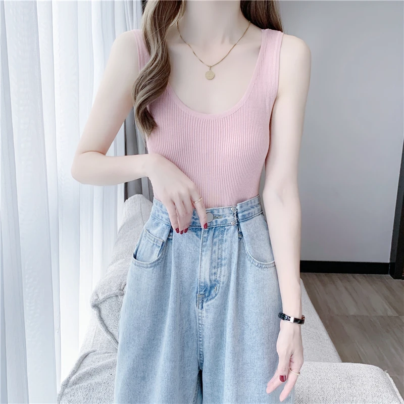 

The minority wears I-neck white camisole outside, and the female wears knitted sleeveless top 3035i,719-7