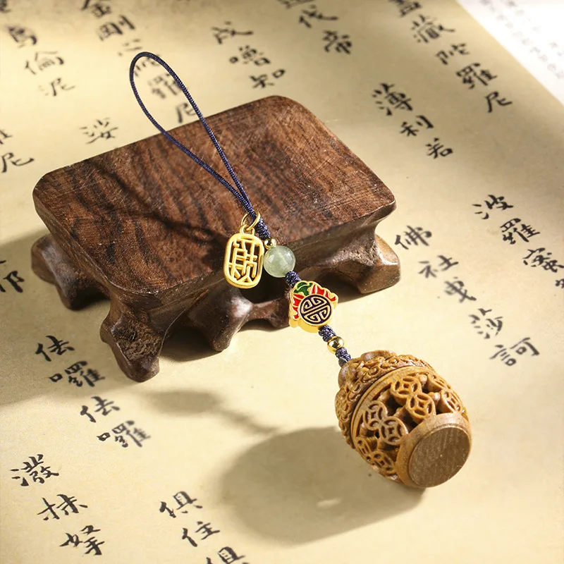 

Green sandalwood corsage copper money sachet hollow carved mobile phone bag key chain pendant