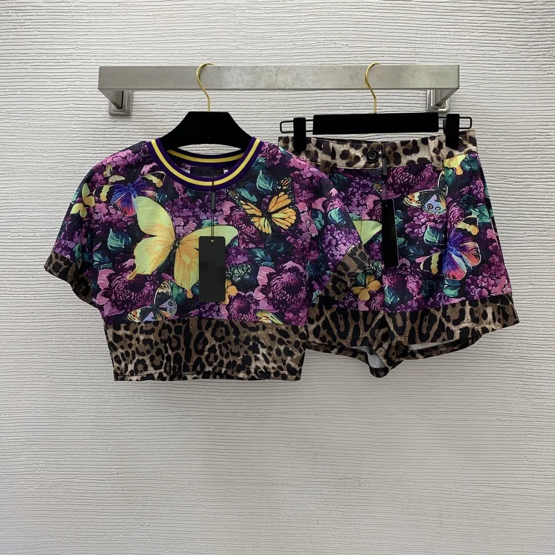 

Женский модельный костюм из двух предметов, топ с коротким рукавом и свободные шорты с фиолетовыми цветами и бабочками, лето 2023