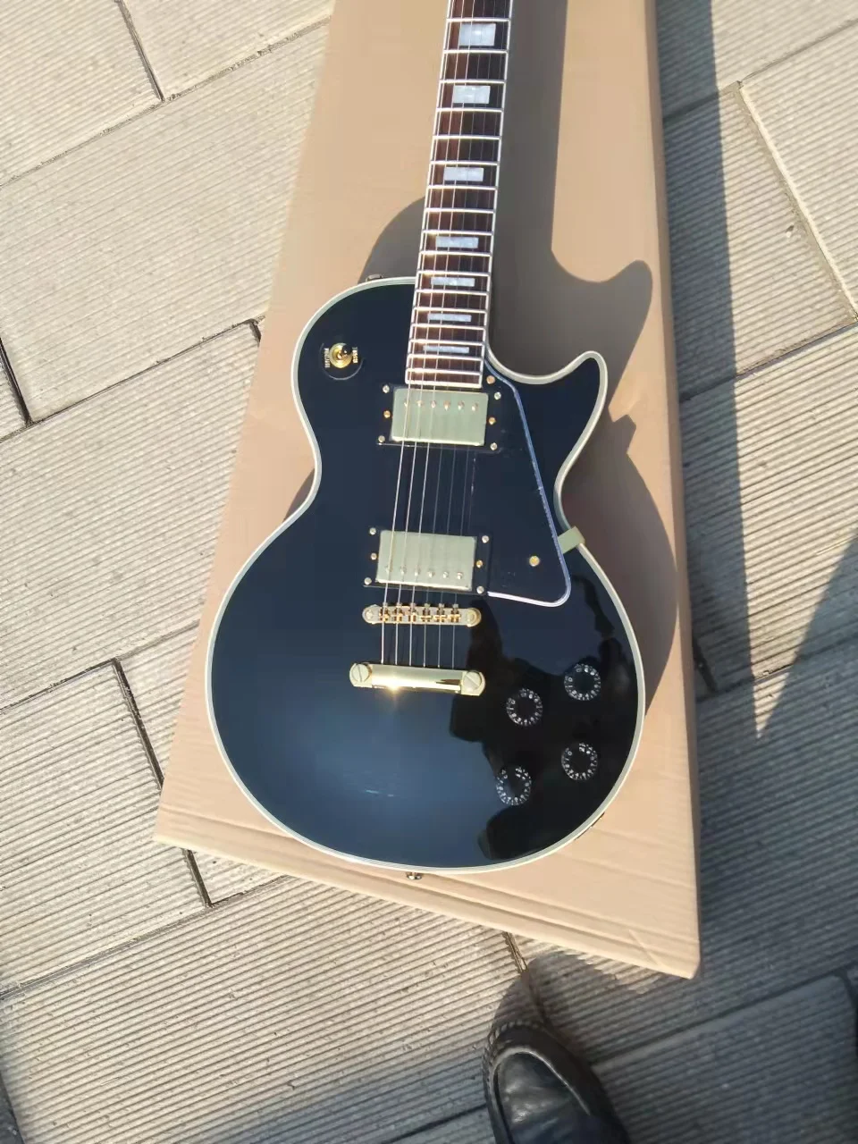 

Customized Electric guitar, black, gold accessories, available, including mail