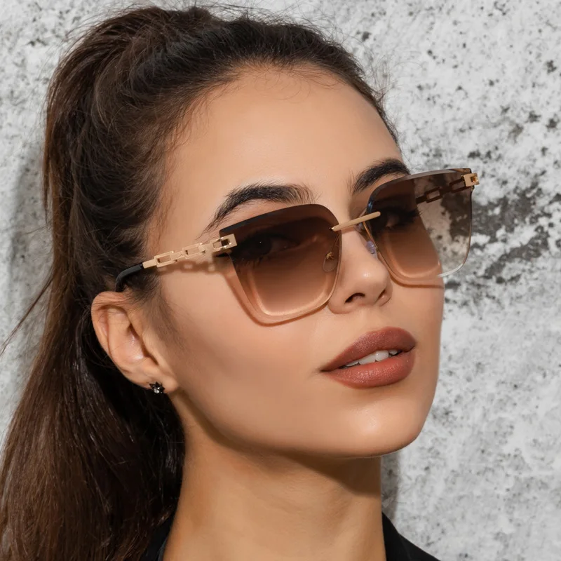 

New Fashion Rimless Cut Edge Sunglasses UV400 Men and Women Metal Hollow Gradient Ocean Lens Glasses Wholesaler