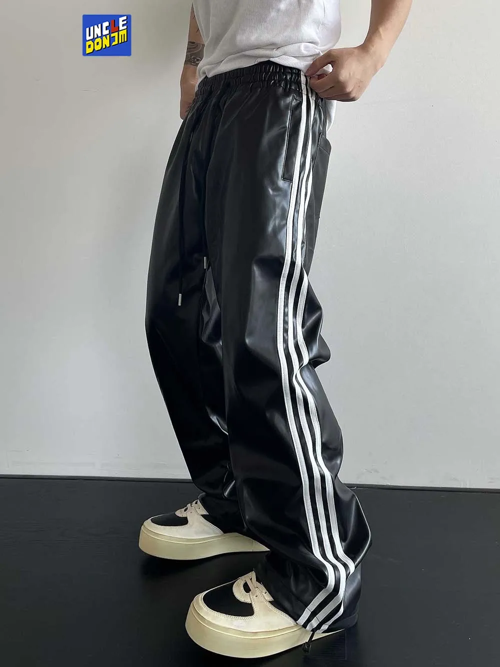 

Side striped PU leather pants men's loose motorcycle riding trousers with drawstring leather pants men street wear Full Length