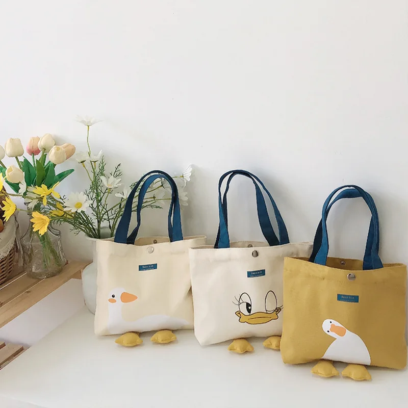 

Custom Flower Picking Cloth/New Cute Fashion Cartoon Soft Cute Small Yellow Duck Lunch Bag Simple Versatile Canvas Handbag