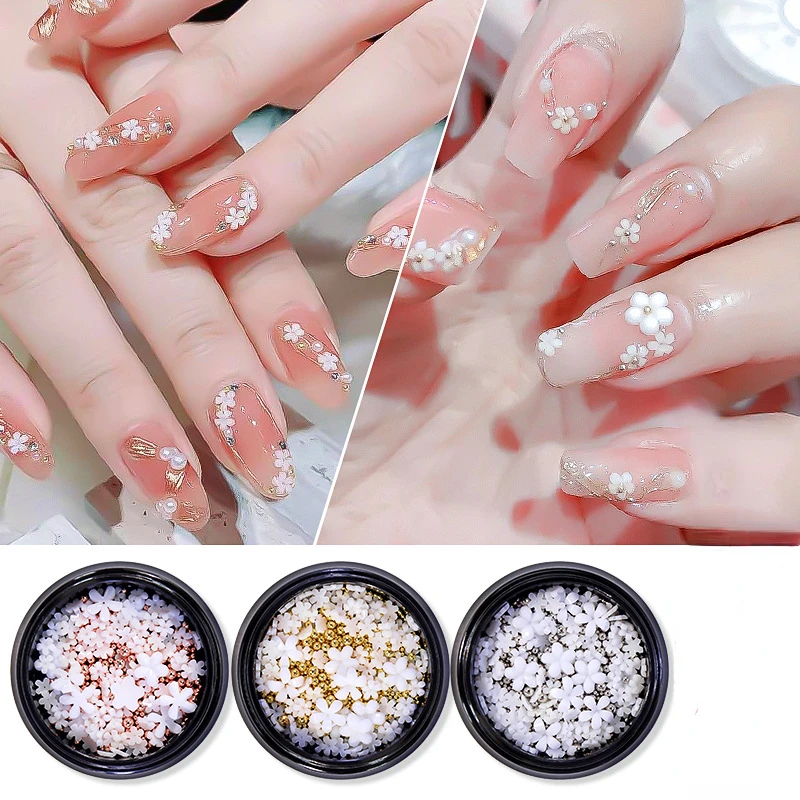 

Новинка 1 коробка миниатюрный цветок из смолы с пятью лепестками маленький белый цветок трехмерные Стразы украшения для ногтей своими рука...