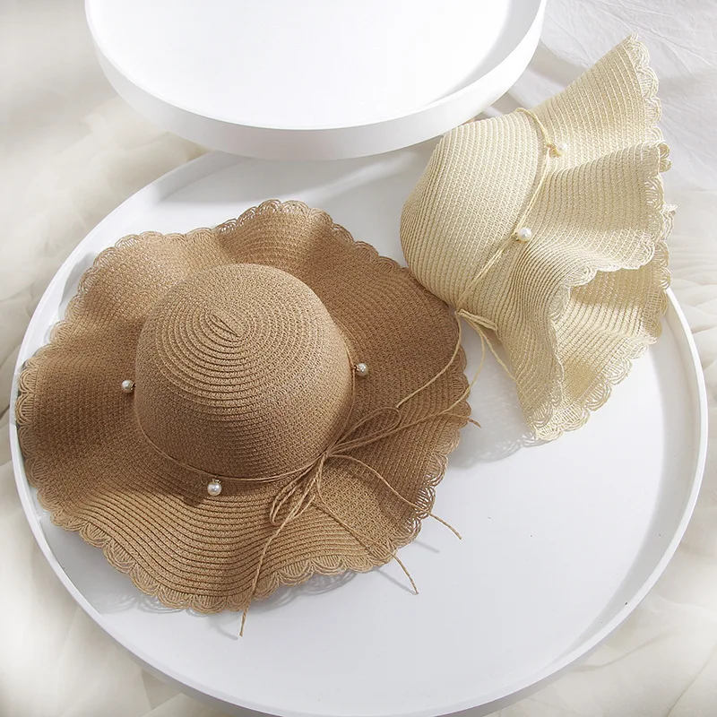 

Straw hat female summer wave along the pearl bow big hat along the tourism beach sun block hat wholesale
