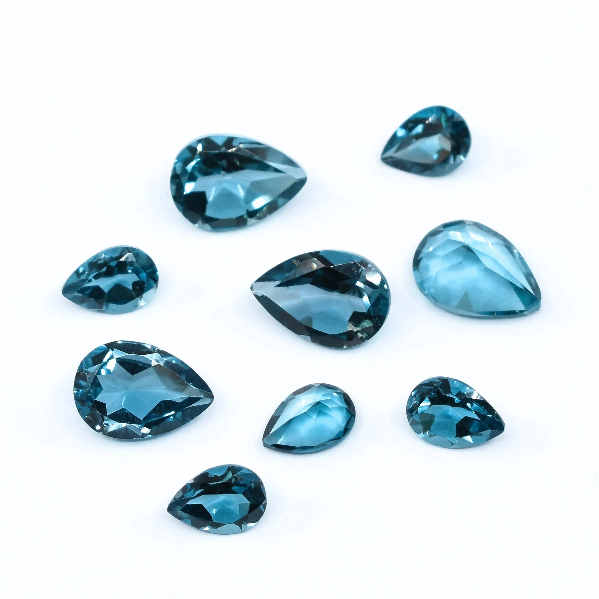 Фото Натуральный топаз London Blue, свободный камень, грушевидная огранка, качество ААА, VVS, различные размеры, оптовая партия №2