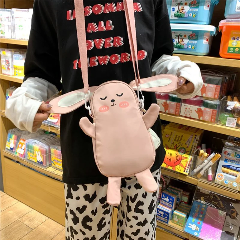 

Japanese Cute and Cute Personality Creativity Little Rabbit Doll Drawstring Wool Ball Soft Girl Crossbody Female Crossbody Bags