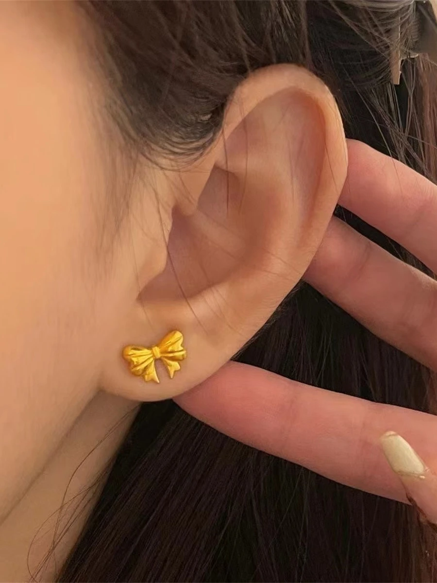 Серьги-гвоздики принцессы с бантом завернутые из 8-каратного золота не