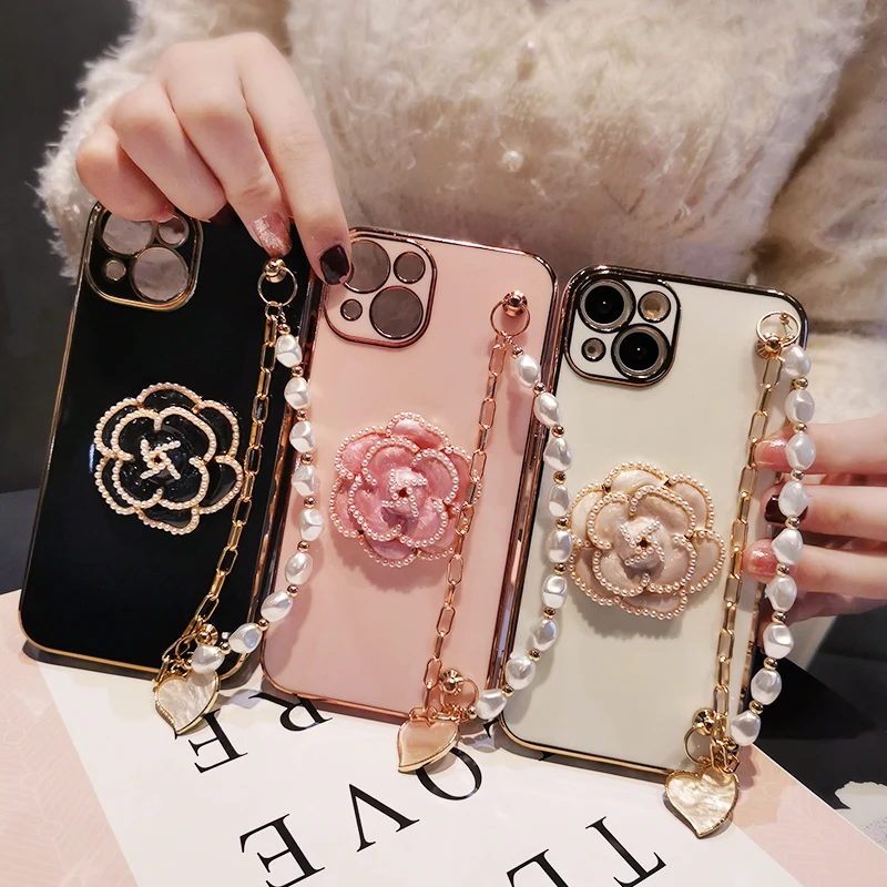 

Pearl Wrist Strap Soft Case for IPhone Camellia Pearl Bracelet Shell Phone Case For IPhone 13 12 Pro Max Phone Case Luxury Metal