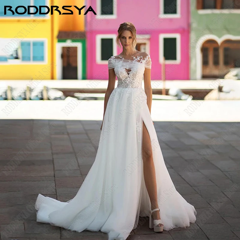 

RODDRSYA O-Neck Appliques Wedding Dress Lace Cap Sleeve Bridal Gown For Women Illusion Buttons robe de mariée fluide Custom Made