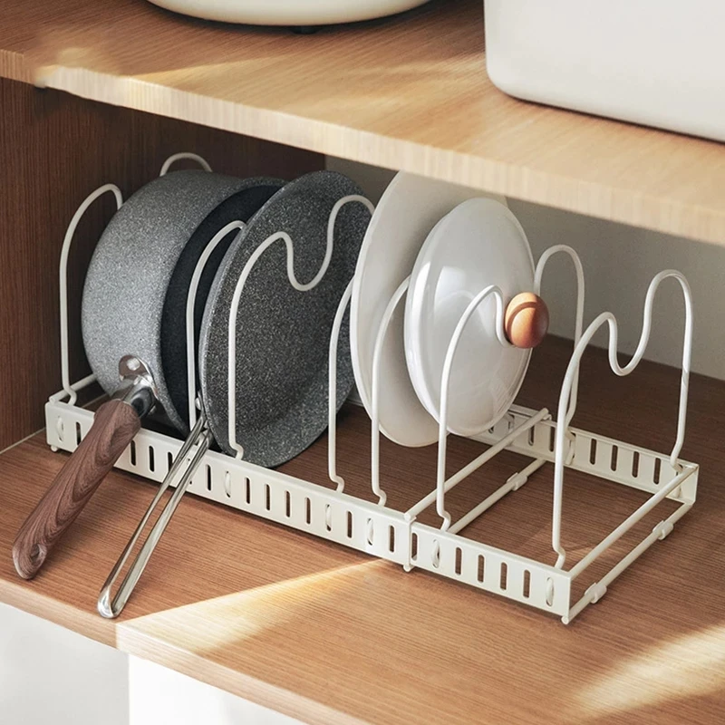 

Pots and pans are used to store clothes dryer accessories in the kitchen. Extended iron plate rack