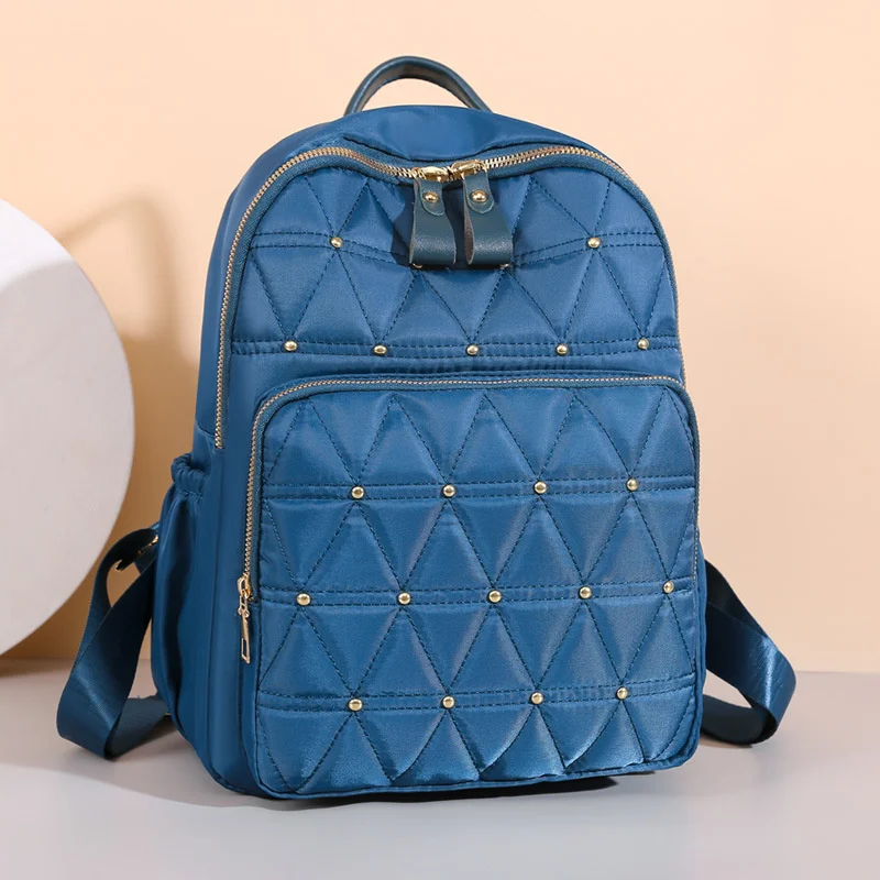 

New Oxford Cloth Backpack Large Capacity Rivet Light Travel Backpack Leisure College Student Embroidered Line Schoolbag