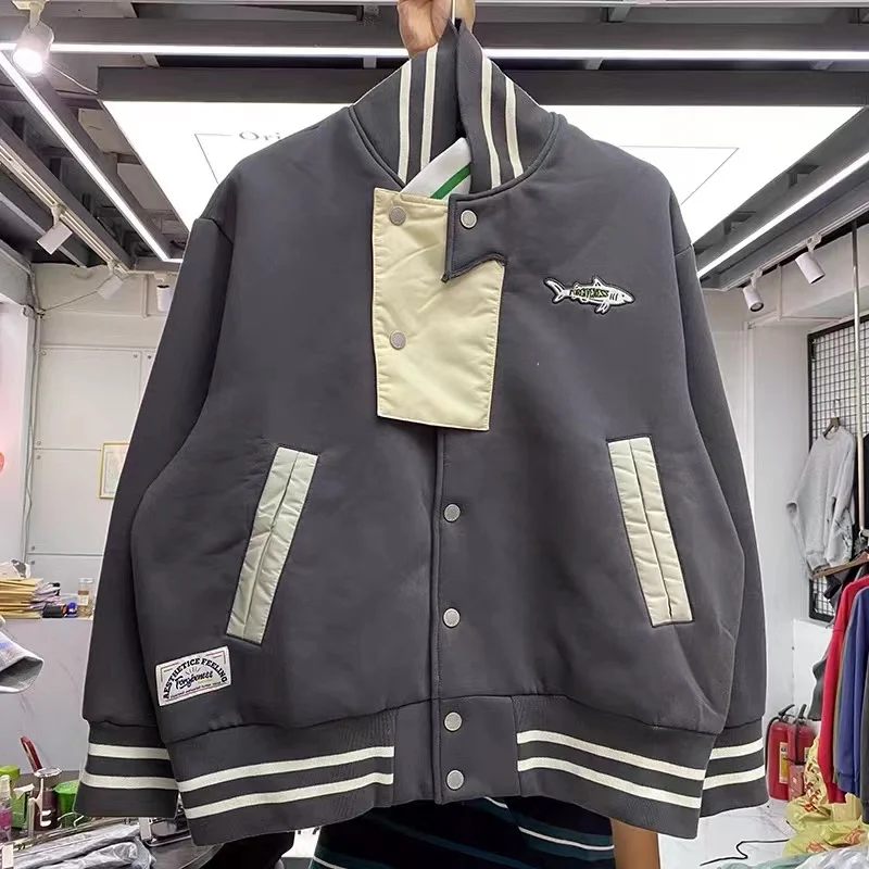 

A two-color, loose-fitting baseball jacket with stitched threads