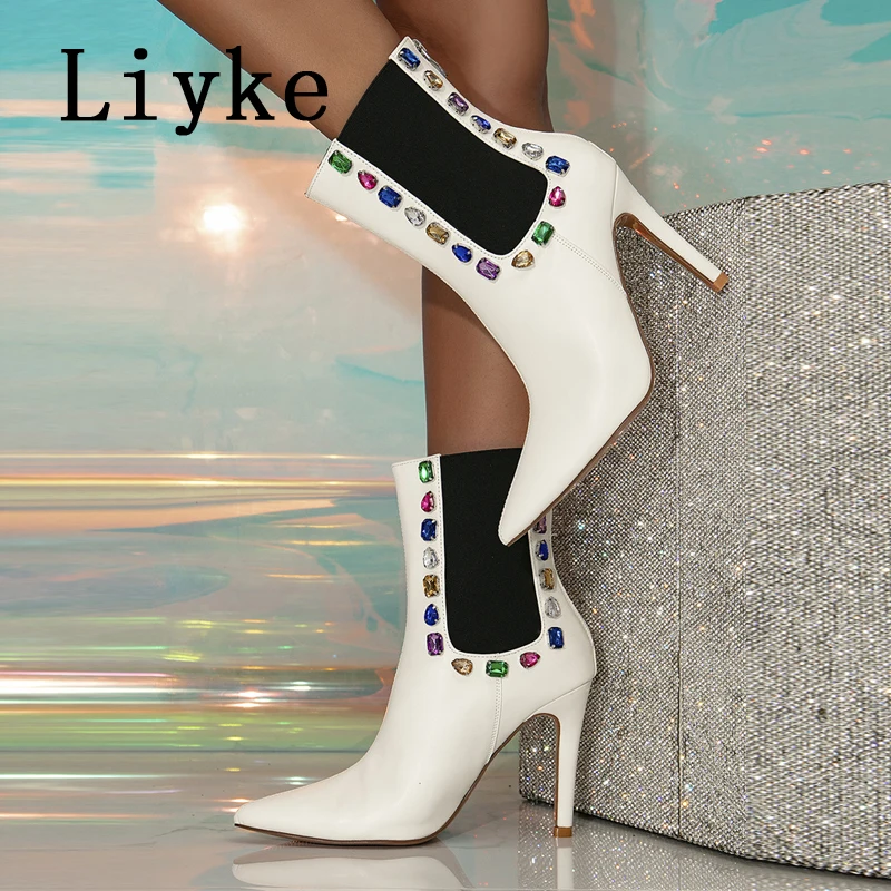

Liyke весенние модные женские ботильоны с кристаллами и драгоценными камнями пикантные с острым носком туфли-лодочки для танцев на шесте на высоком каблуке женские белые ботинки челси на молнии