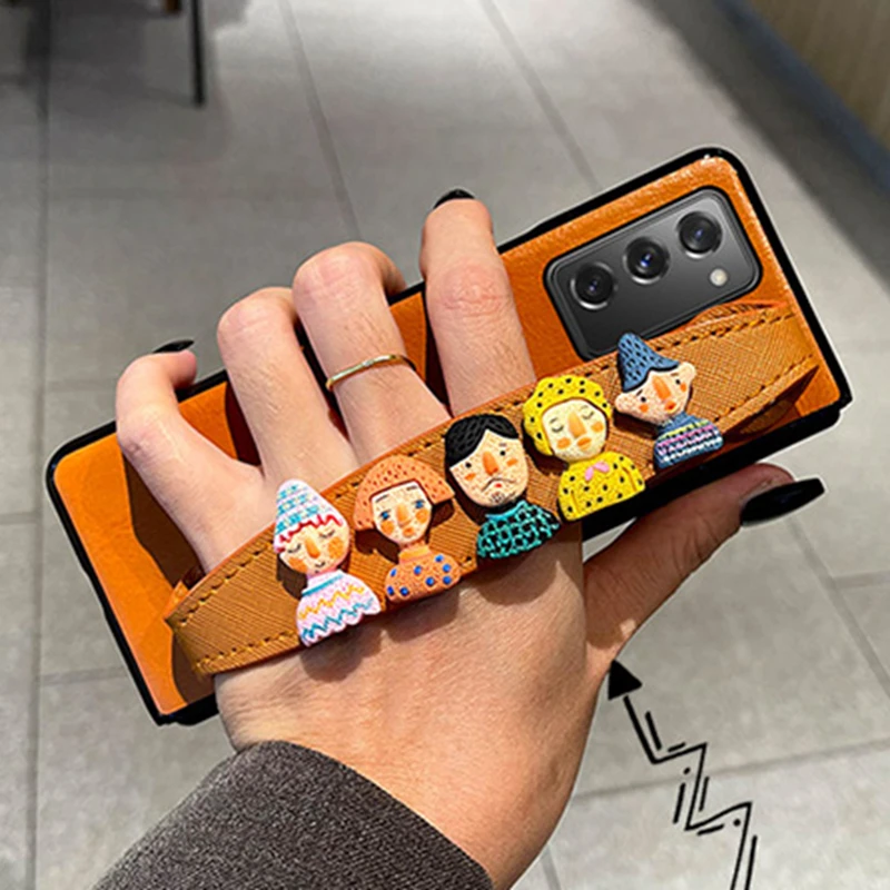 

Cute Cartoon doll Wristband Leather Case For Samsung Galaxy Z Fold 2 3 W21 W22 5G Girl Fashion Hand Holder Back Cover