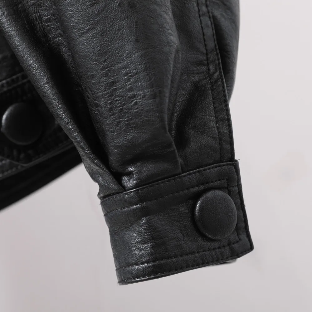 Single breasted loose version of women's short black lapel leather coat