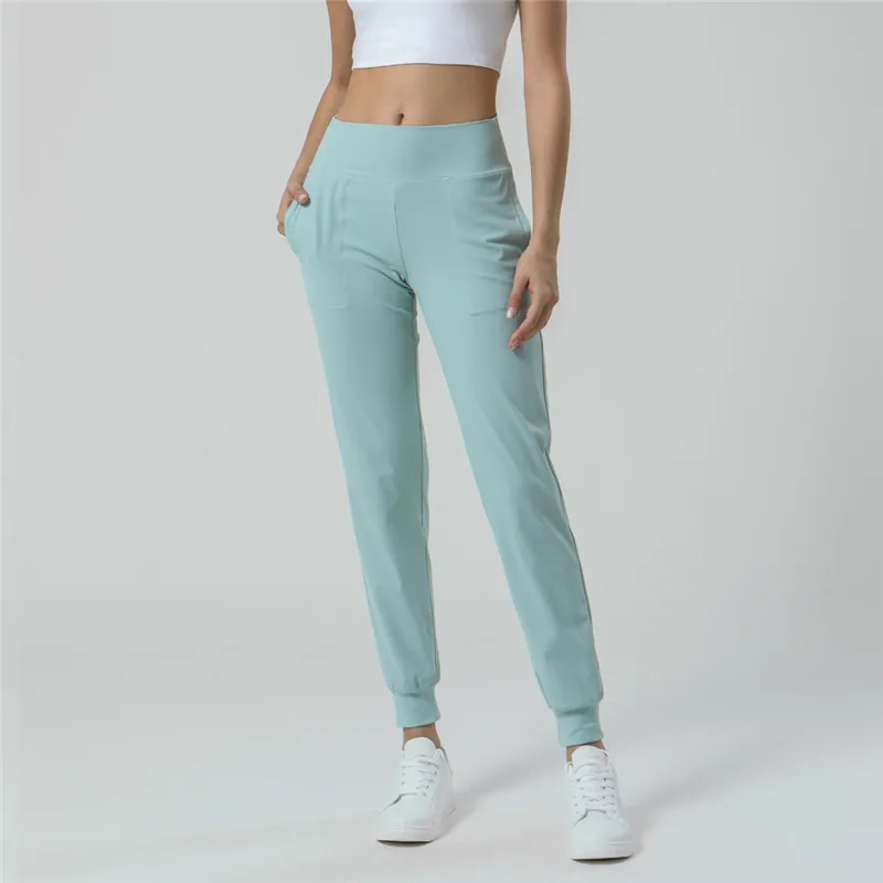 

Solid Color Women Sports Pants Casual Jogging Soft Yoga Leggings Fitness Training Gym Trousers Loose Foot Pockets Comprehensive