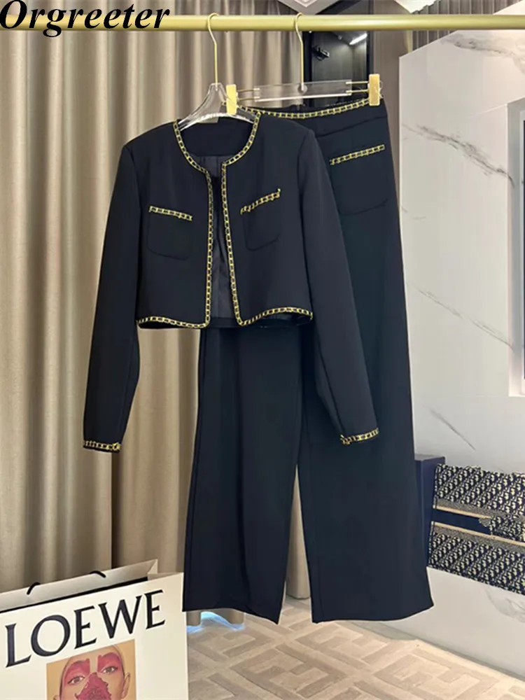 

Женский костюм из двух предметов: короткая куртка и брюки с высокой талией и широкими штанинами