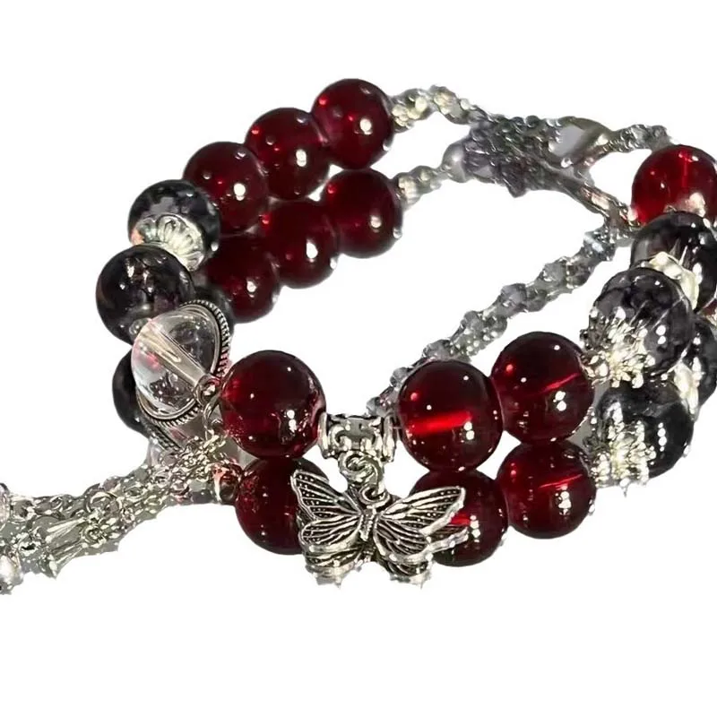 Женский браслет-цепочка с подвеской в виде креста красными кристаллами и перьями