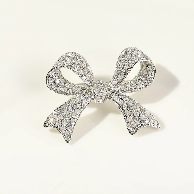 

Korean Simple Silver Bow Brooch Fashion Elegant Collar Crystal Pin Jewelry Anti Light Buckle Cardigan Accessories for Woman
