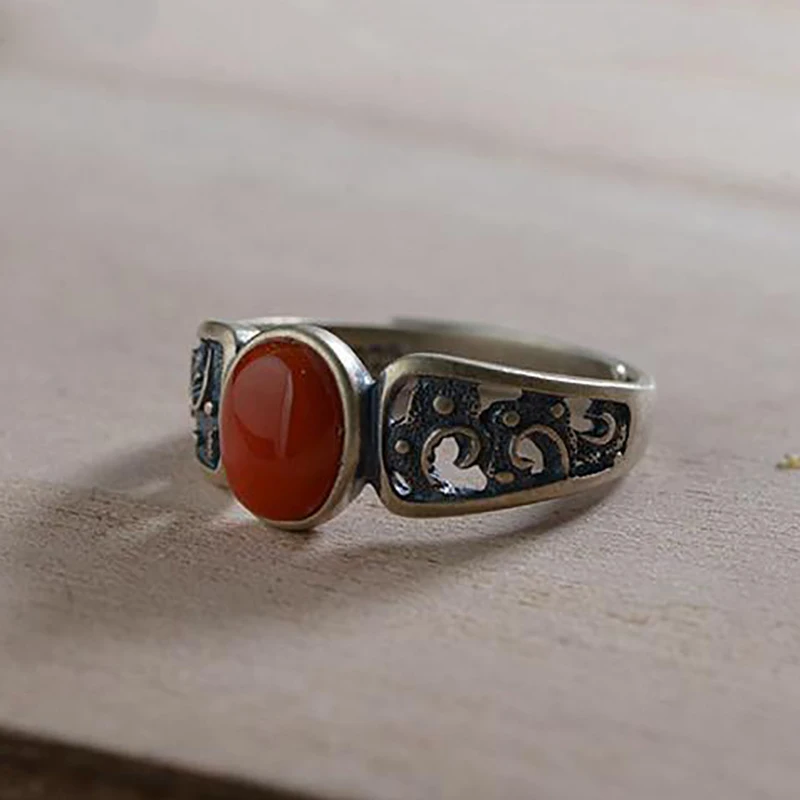 

Creative silver inlaid hollow pattern oval southern red tourmaline cold wind niche design process opening adjustable female ring
