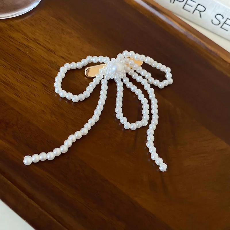 Заколка для волос с бантом из искусственного жемчуга и цветком текстура