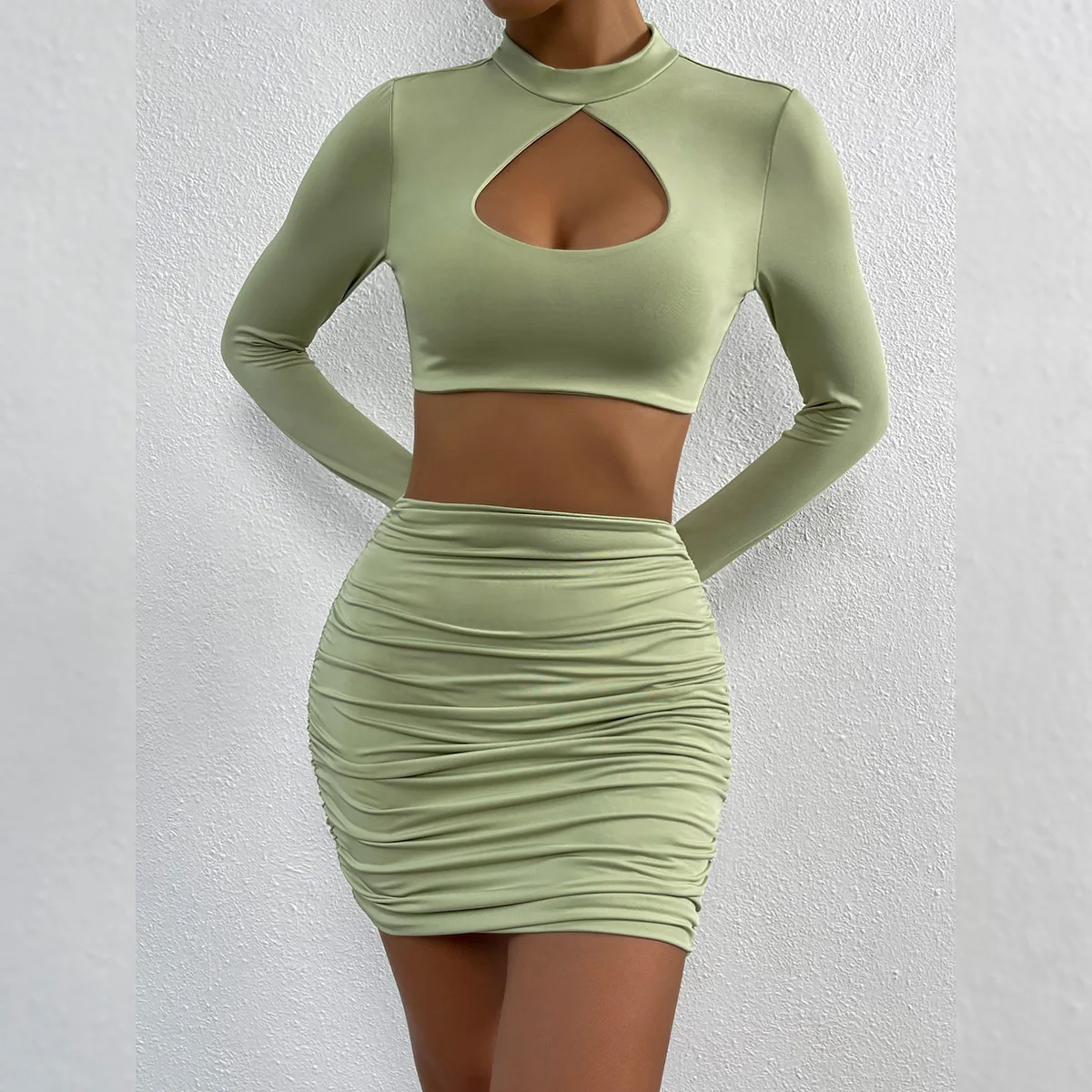 

Spring And Autumn Fashion New Womens Solid Color Sexy Hollow Out Long Sleeved Hip Wrap Skirt Wrinkle Exposed Navel Two-piece Set