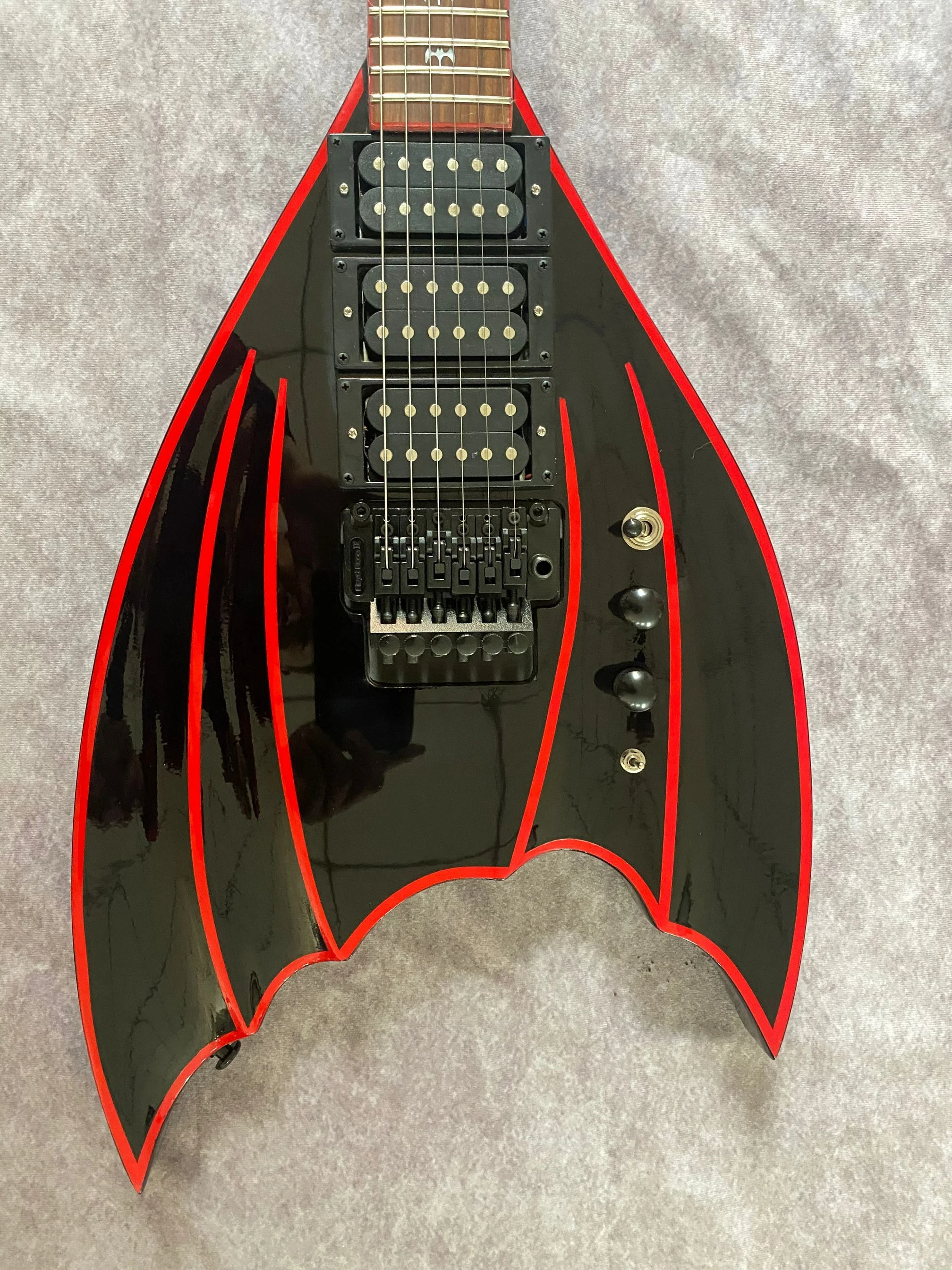 

Special Shape Bat Wing Black Electric Guitar, Mahogany Body Black hardware, Floyd Rose Tremolo Bridge, HHH Pickups, Bat Inlay