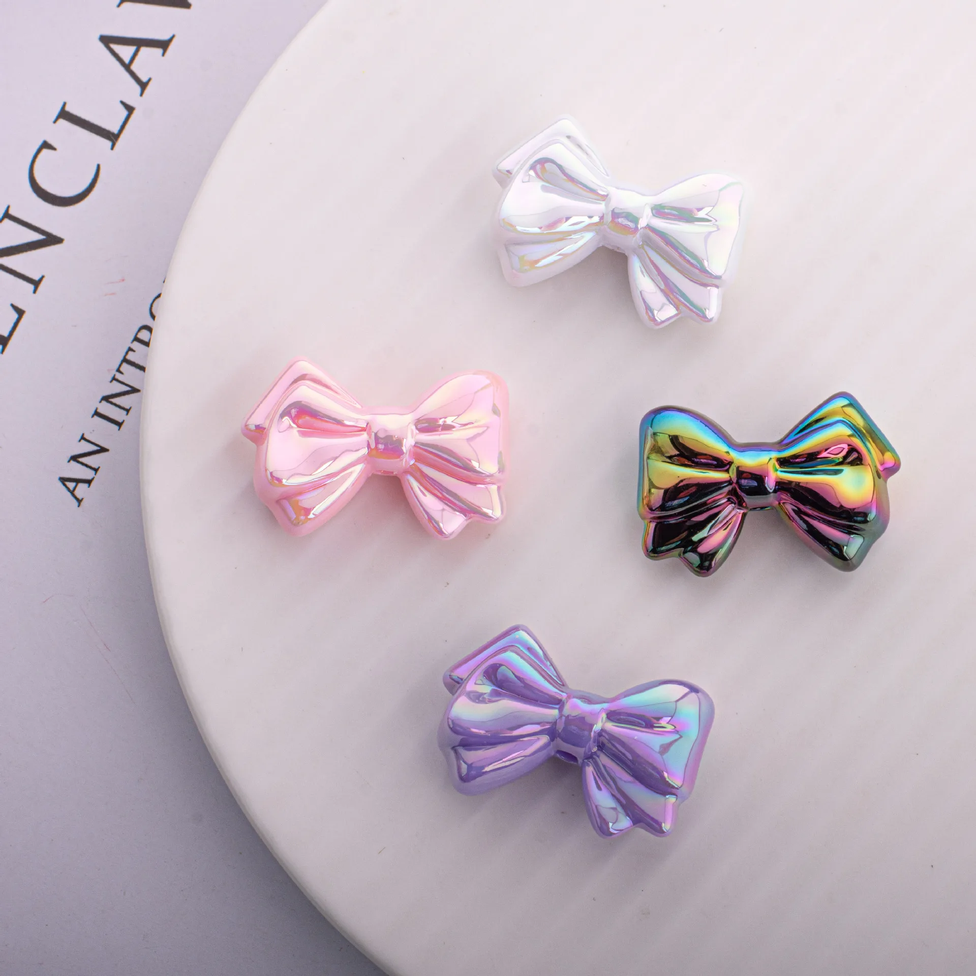 

Wholesale 100pcs 31*21mm AB Bright Colors Ribbon Knot Bow Acrylic Jewelry Beads Ornament Accessory Material Plastic Loose Spacer