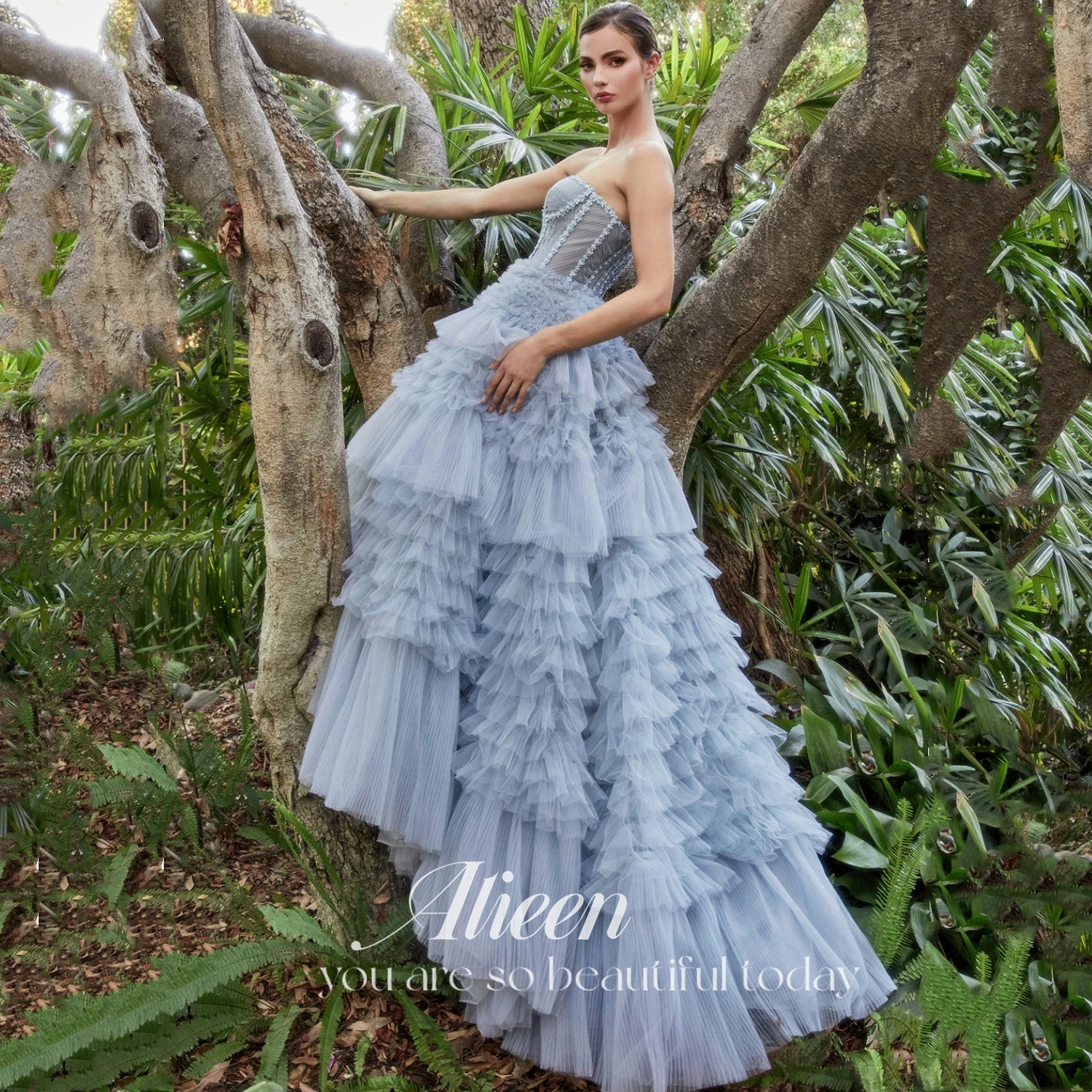 

Aileen Princess Gown Features Beautiful Pleated Corset Bodice Blossom Details Adjustable Tie-back Ruffle Tulle Ball Gown