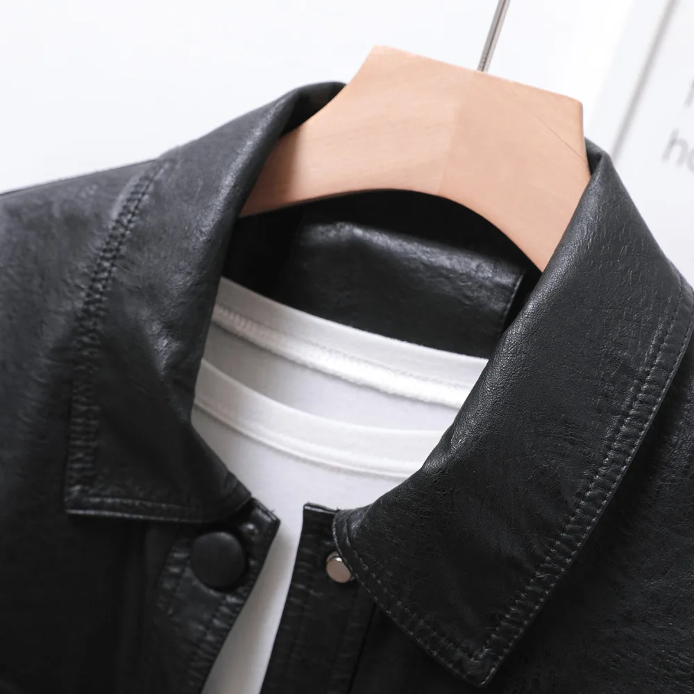 Single breasted loose version of women's short black lapel leather coat