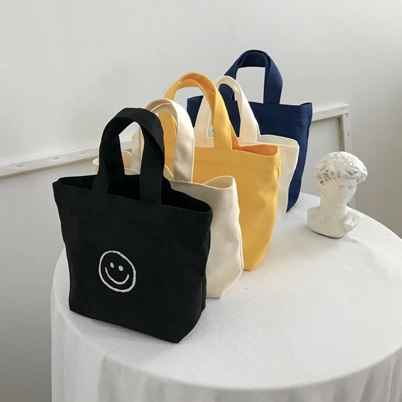 

2022 Korean Version Ins Super Hot Cute Small Bag Smiling Face Canvas Bag Schoolgirl Bento Bag Handbag Mini Storage Bag