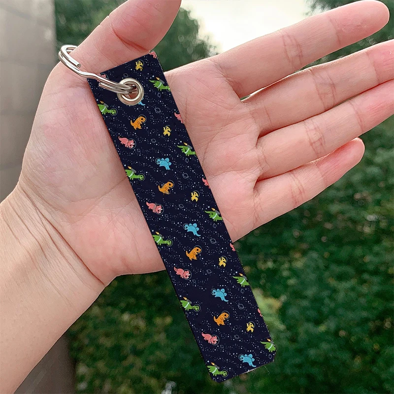 

Dinosaurs In Space Leather Keychain Strap Keyrings Cute Hanging Holder Bag Car Wallet Trinket Keychain Hanging Decoration