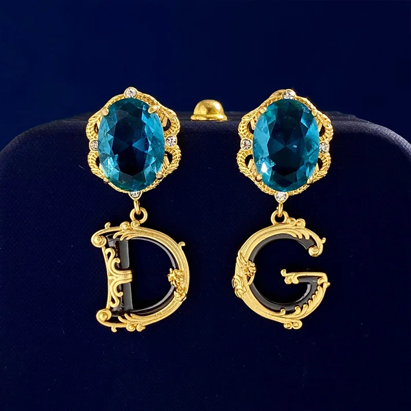 

Light Luxury Retro Palace Style Gray Blue Big Gemstone Earring DG Letter Embossed Vine Design Asymmetric Earrings Wholesale