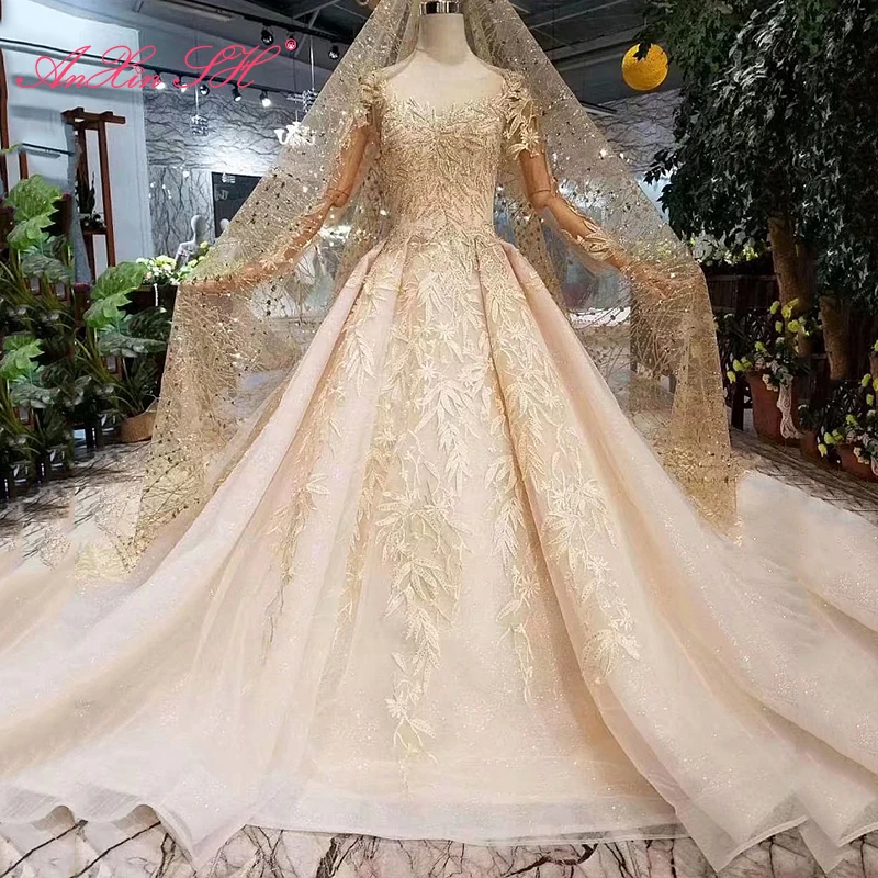 

Роскошное кружевное блестящее свадебное платье AnXin SH цвета шампанского с круглым вырезом, бисером, кристаллами, иллюзией, длинными рукавами...