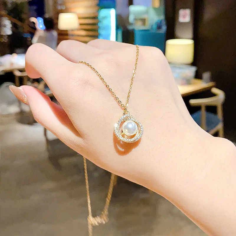 

Jewellery Style Titanium Steel Necklace Female Fashion Temperament Hollow Out Bird's Nest Bright Pearl Pendant Advanced Sense