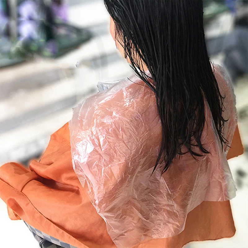

200pcs Disposable Hairdressing Capes PE Waterproof Apron Cutting Dye Hair Cape Barber Transparent Hairdressing Cloth