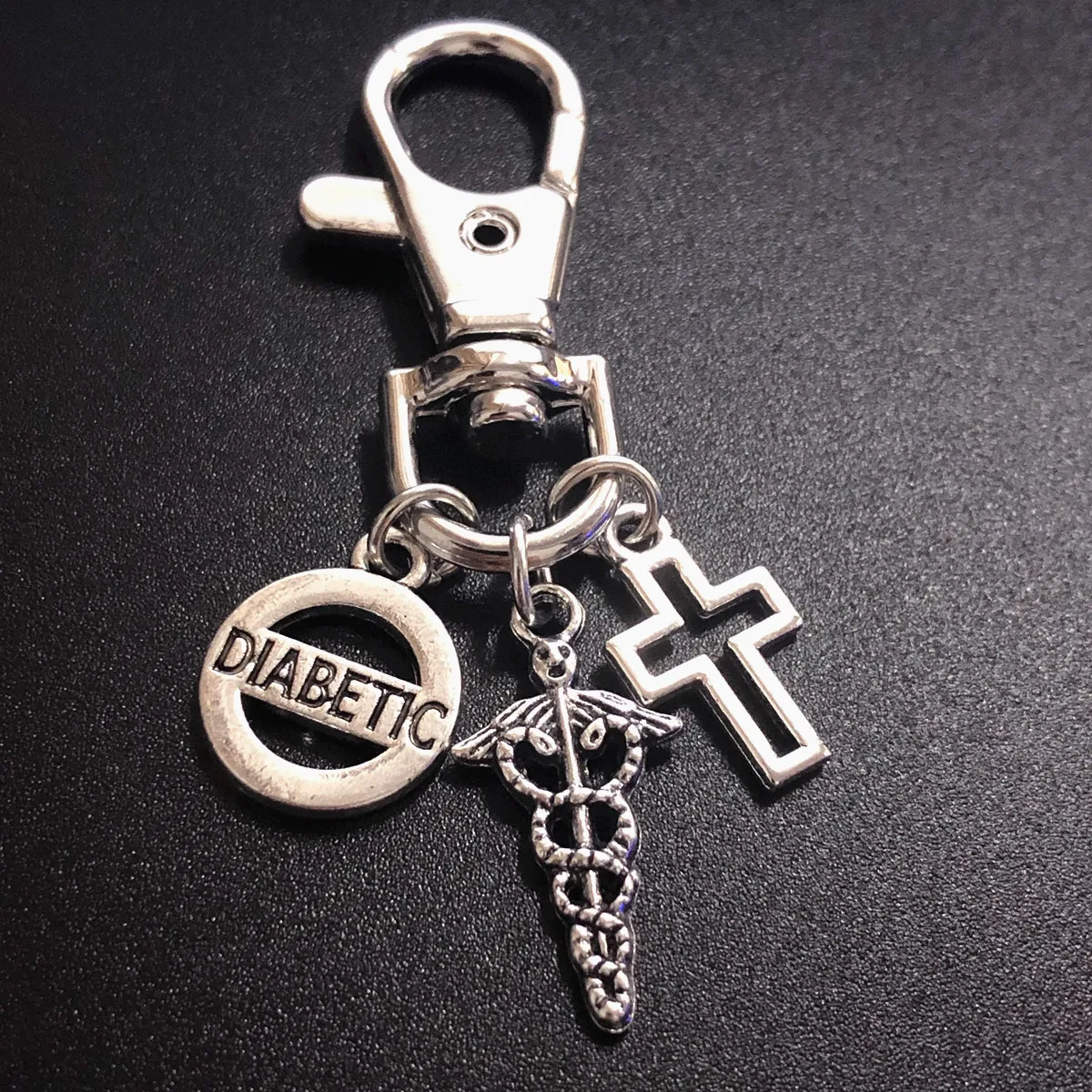 

Simple personality double snake angel wings scepter hollow cross keychain