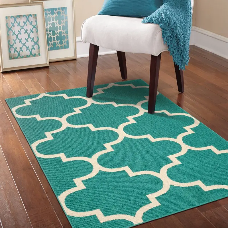 

Fascinating Teal/Ivory 45"x66" Geometric Indoor Area Rug - Intricately Woven Design with Chic Colors.