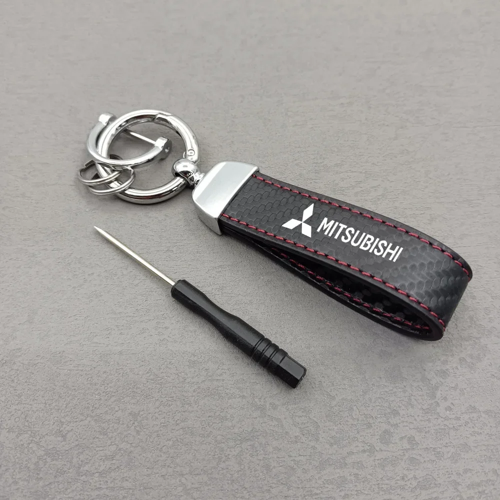 

Брелок для ключей с логотипом автомобиля, брелок для ключей из натуральной кожи, однотонный брелок с пряжкой для ключей для Mitsubishi Lancer Asx Outlander Pajero L200 Ralliart