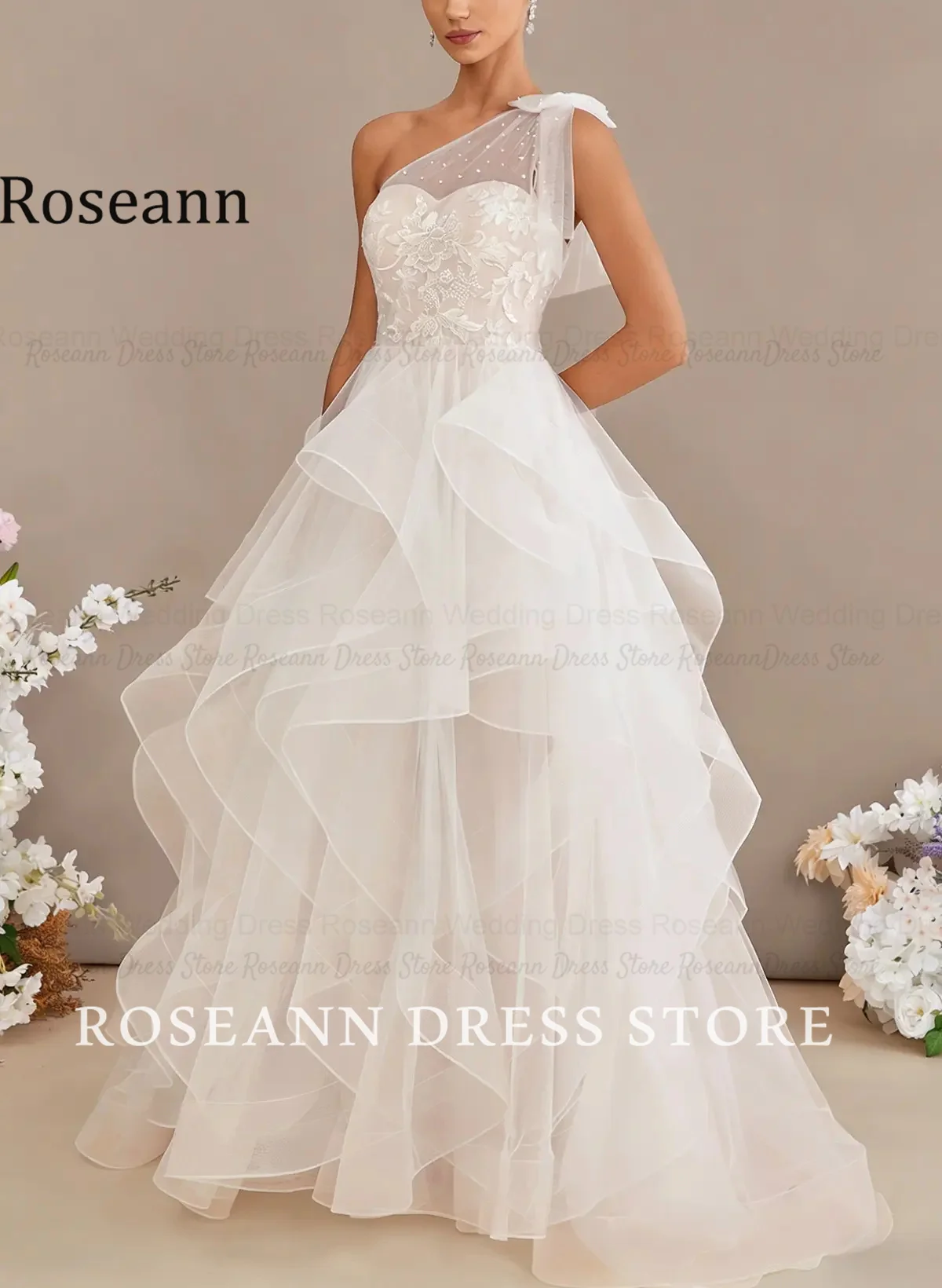 Фото Свадебное платье Roseann с бантом, на одно плечо, кружевное, с эффектом иллюзии, многоярусное, с рюшами из тюля, А-силуэт, с шлейфом, свадебное платье на заказ. №2